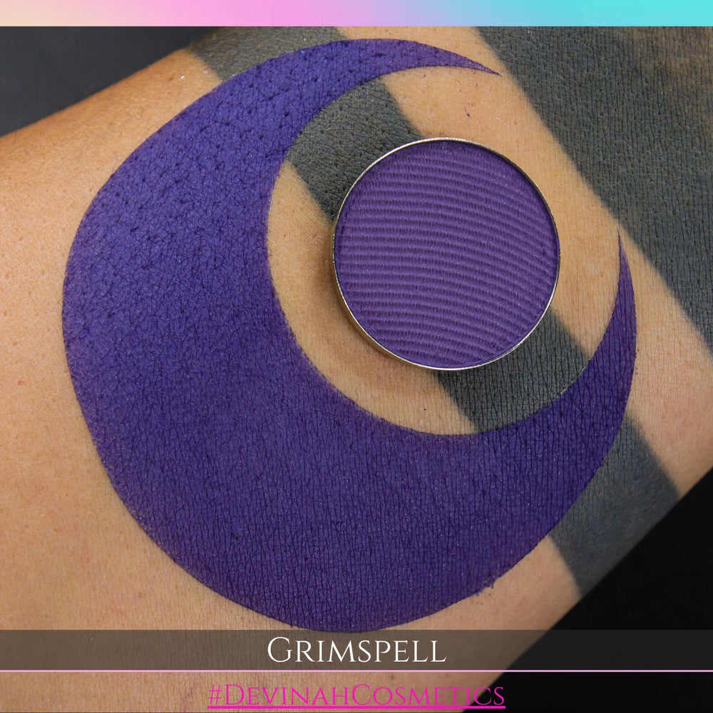 Purple circular makeup eyeshadow pan of a matte pigment called 'Grimspell' 
