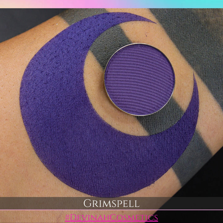 Purple circular makeup eyeshadow pan of a matte pigment called 'Grimspell' 