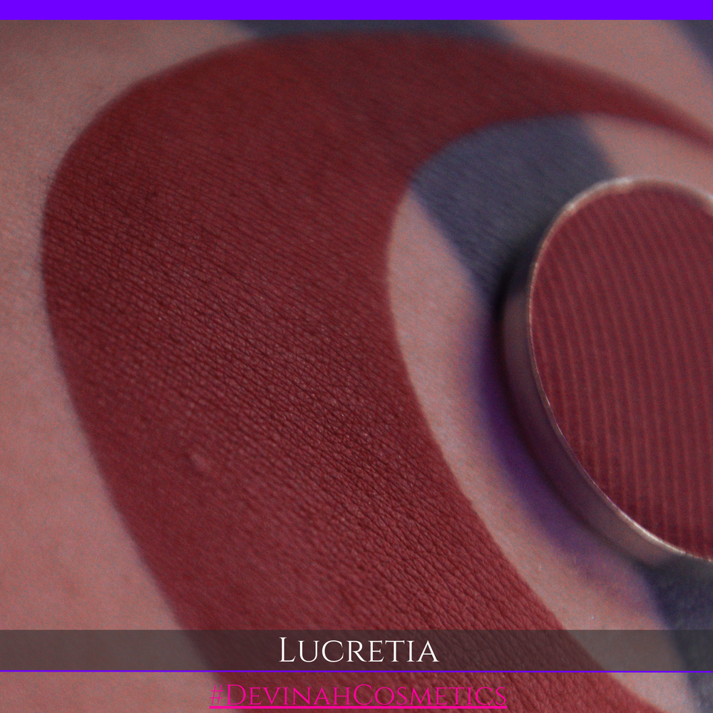 Close-up of a makeup product labeled 'Lucretia' on a textured surface with a purple border.