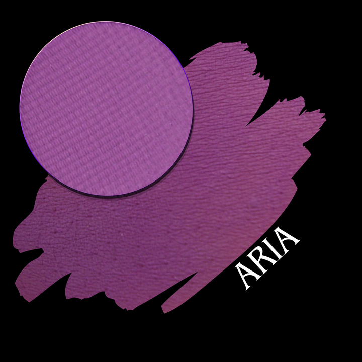 A circular makeup pan in a purple shade is shown over a matching purple swatch on a black background, with the name ARIA in white text.