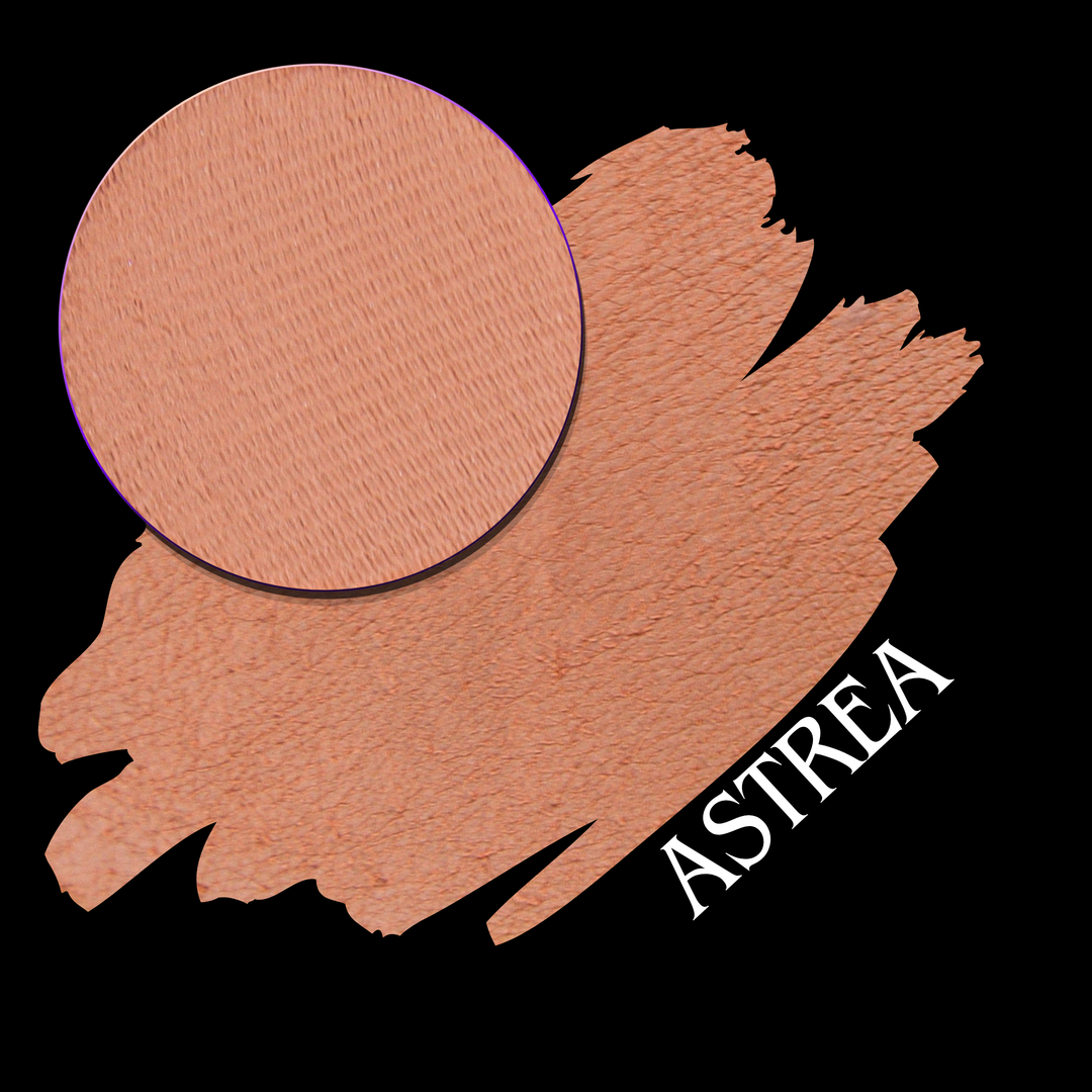 A makeup swatch showing a circular pressed powder pan layered overa swatch of the same peachy nude shade, with the name ASTREA in white text on a black background.