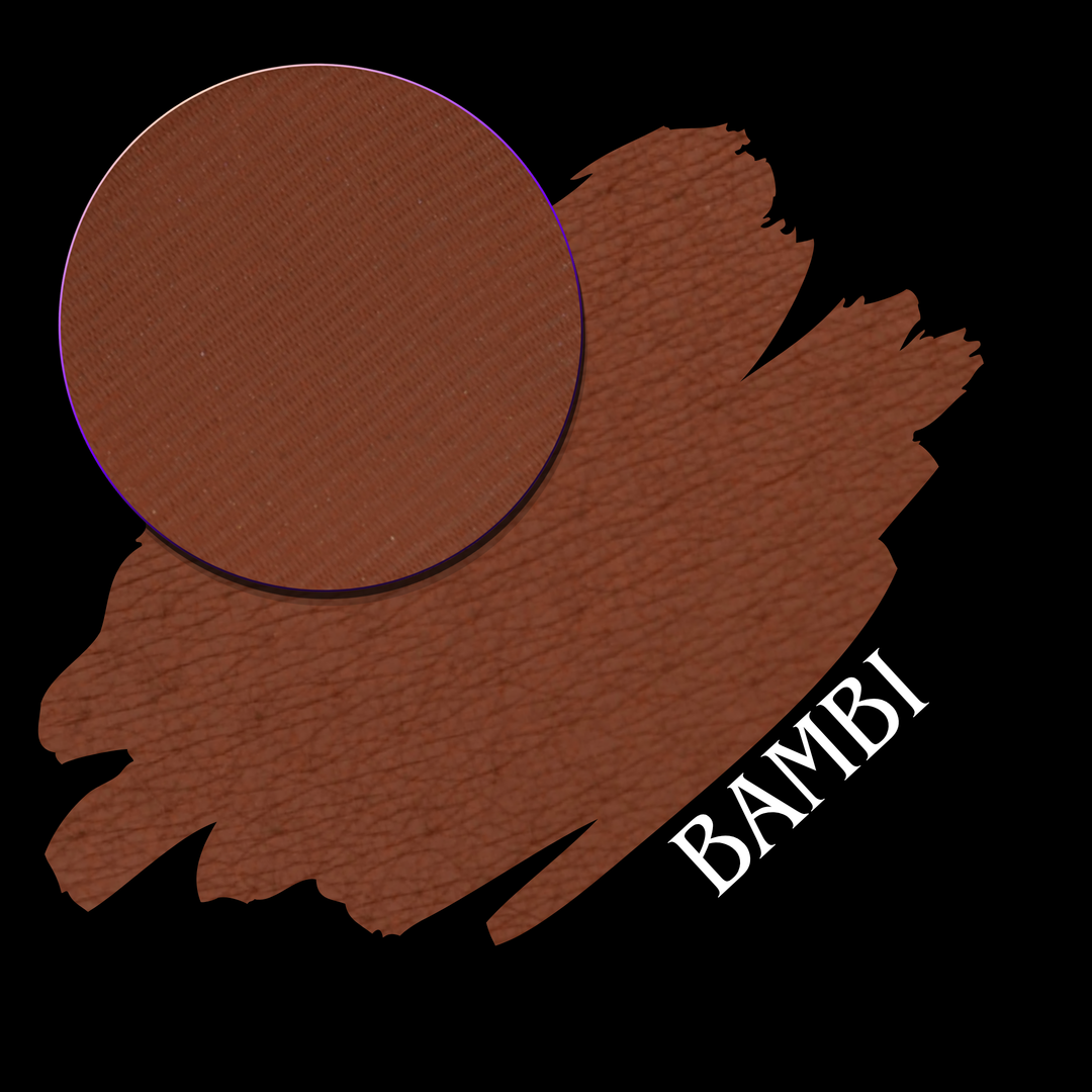 A brown makeup swatch showing a circular pressed powder eyeshadow pan on a larger swatch of matching brown pigment, with the word 'BAMBI' in white on a black background.