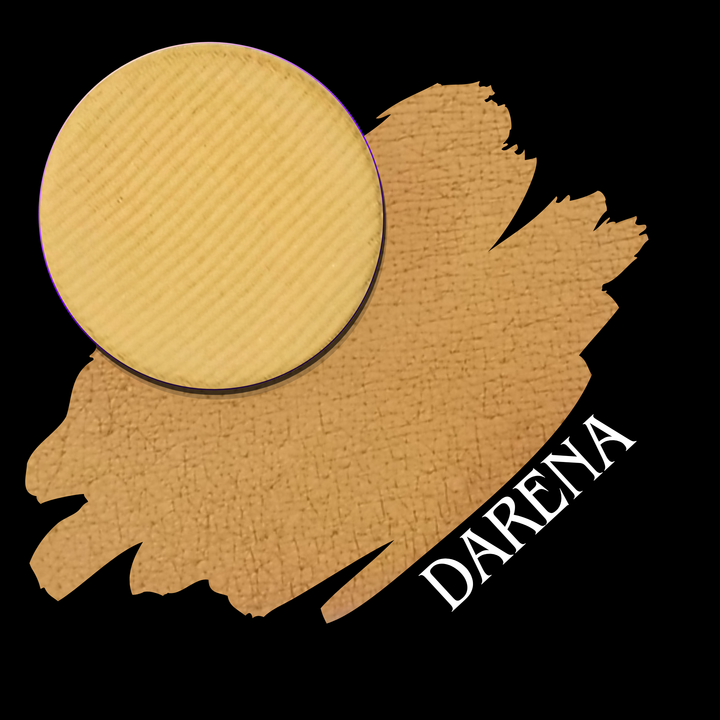 A circular makeup eyeshadow pan in a warm golden-beige shade is placed over a swatch of the same color on a black background, with the word 'DARENA' in white text.