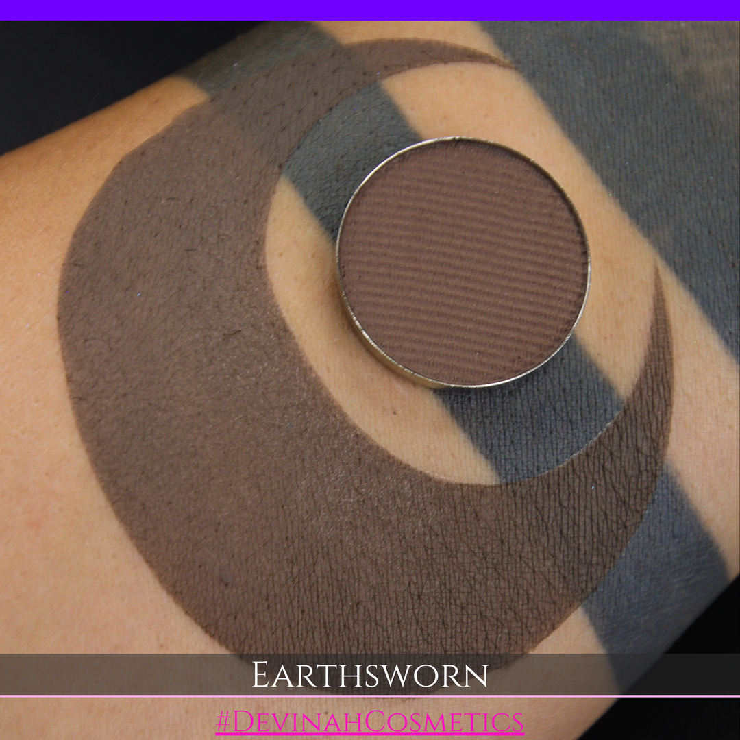 A makeup swatch showing a brown eyeshadow with a circular eyeshadow makeup pan, labeled 'EARTHSWORN' on a black background.
