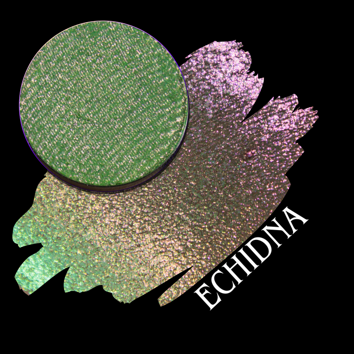 A circular makeup eyeshadow pan of a shimmering multichrome eyeshadow with a green to yellow to pink shift shown in the swatch, named Echidna made by Devinah Cosmetics.