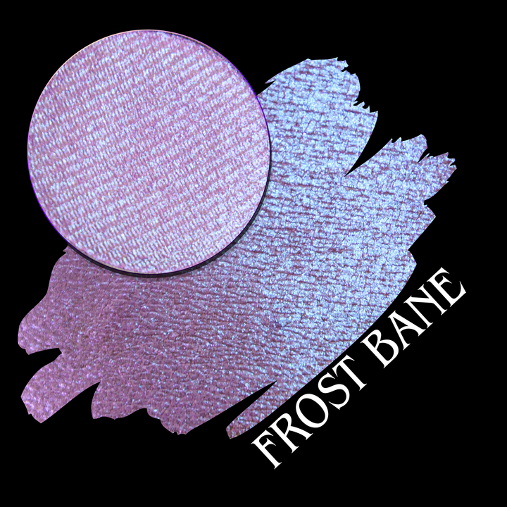 A cosmetic color swatch showing a shimmering baby pink and baby blue eyeshadow named 'Frost Bane,' with a circular eyeshadow pan close-up on a black background.
