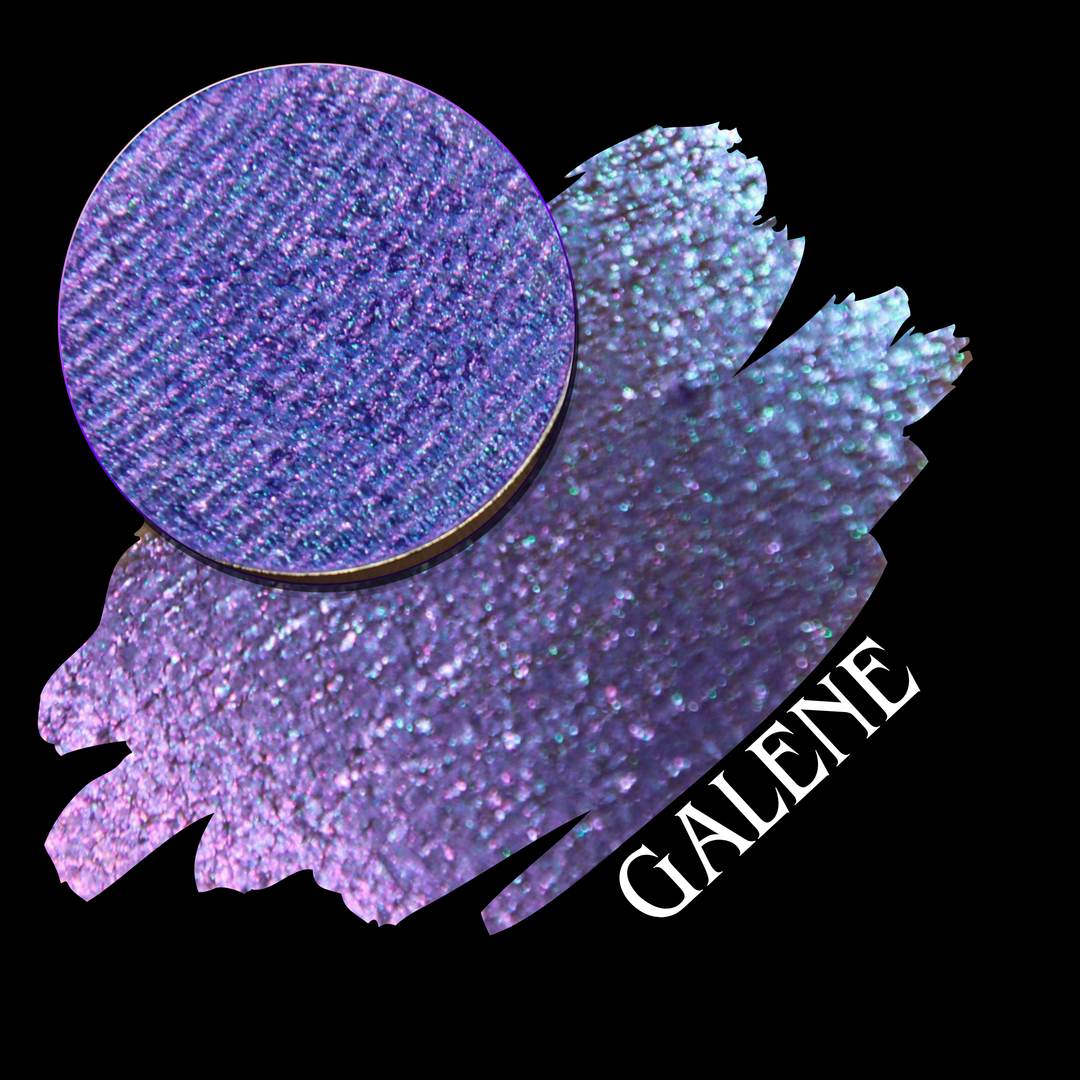 A round eyeshadow pan labeled 'GALENE' made by Devinah Cosmetics, placed over a large crescent moon swatch of the same shimmering shifty eyeshadow on skin. The duochorme multichrome eyeshadow has a shift between colors pink, purple, blue.