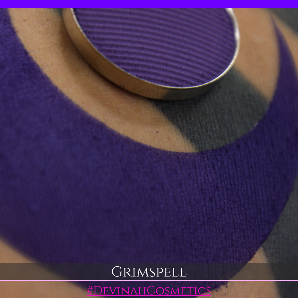 A close-up of a purple matte eyeshadow swatch and the eyeshadow pan. The text 'GRIMSPELL' and '#DEVINAHCosmetics' are displayed at the bottom.
