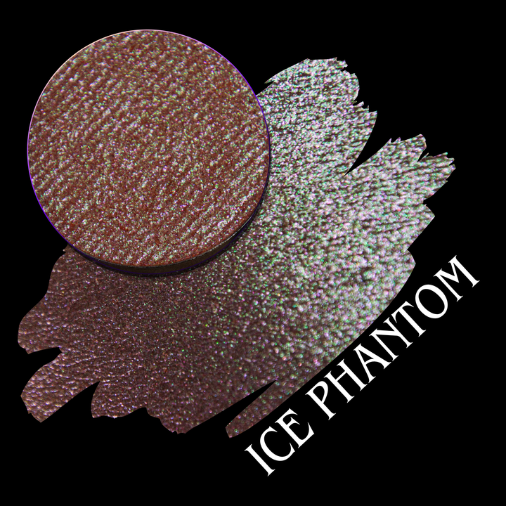 A makeup swatch and an eyeshadow pan in a coral peach color with pink and green iridescent sparkles, labeled 'ICE PHANTOM' on a black background hand made by Devinah Cosmetics.