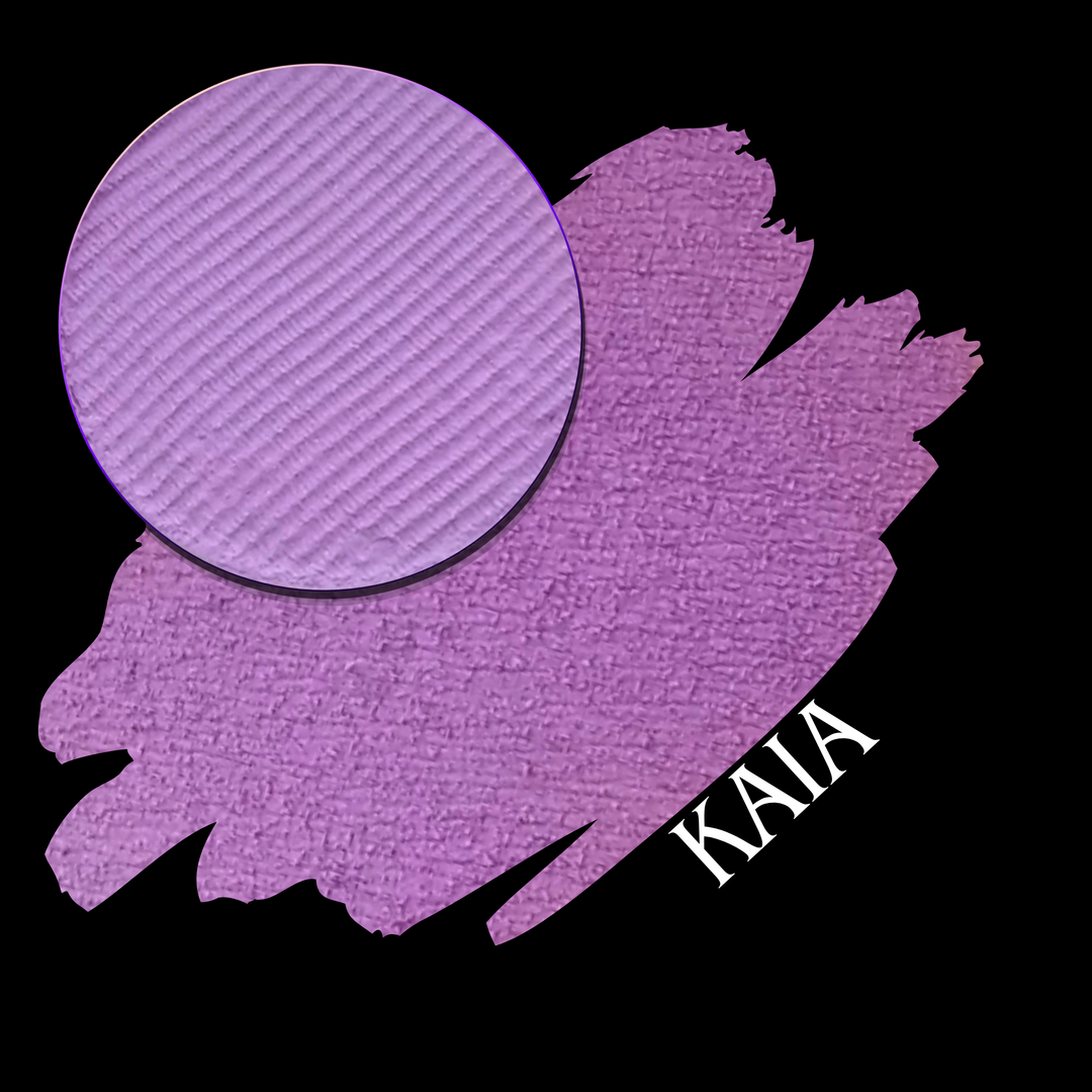 A close-up of a purple eyeshadow pan shown over a matching purple swatch on a black background, with the shade name 'KAIA' in white text.