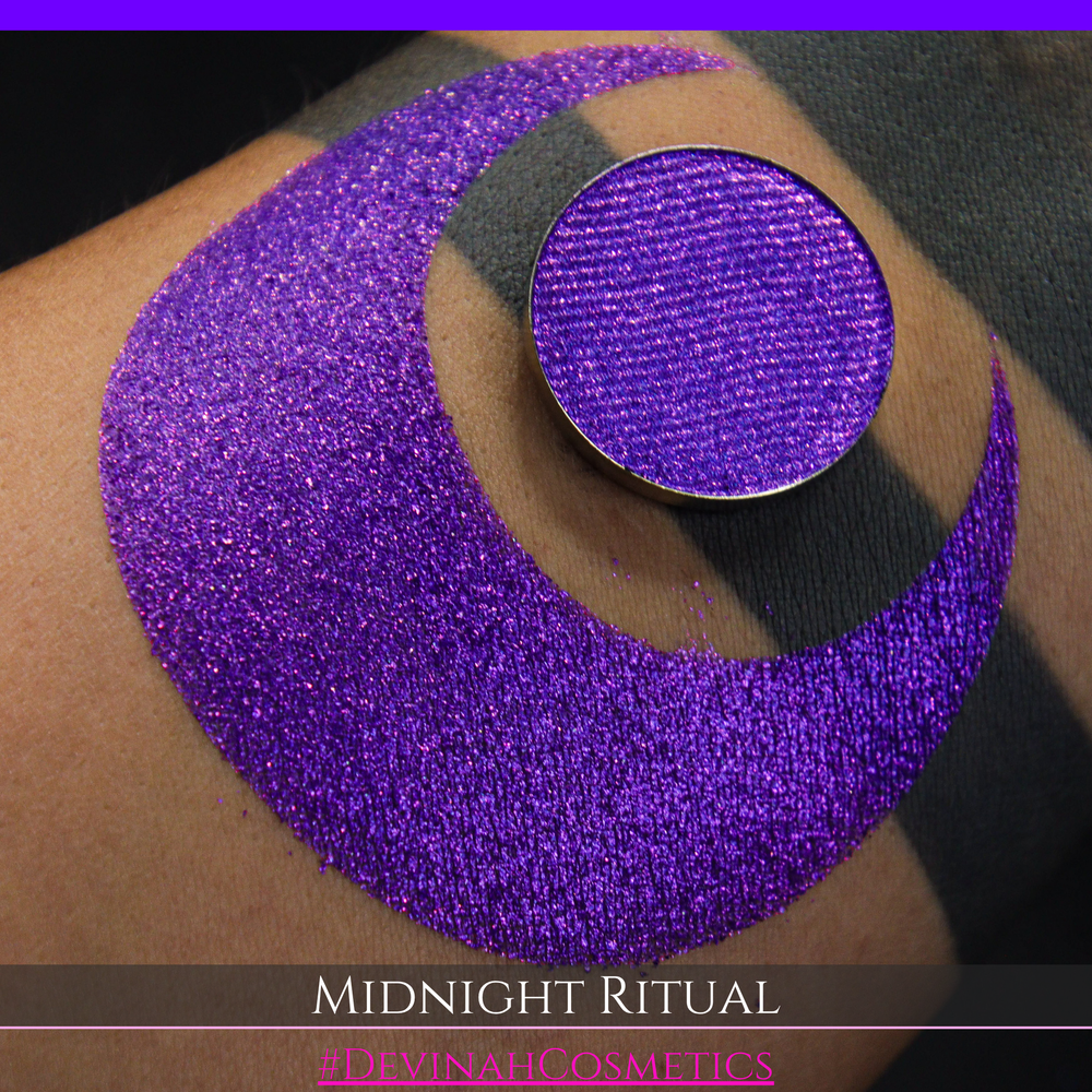 A close-up of a large glittery purple makeup swatch and a matching round pan of purple eyeshadow. Text at the bottom reads 'MIDNIGHT RITUAL' and '#DEVINAHCOSMETICS'.