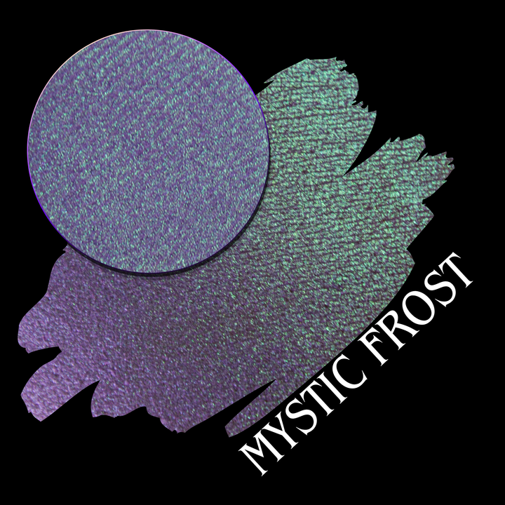 A textured eyeshadow swatch labeled 'MYSTIC FROST' with a purple-to-teal gradient, showing a circular eyeshadow makeup pan on a black background hand made by Devinah Cosmetics.