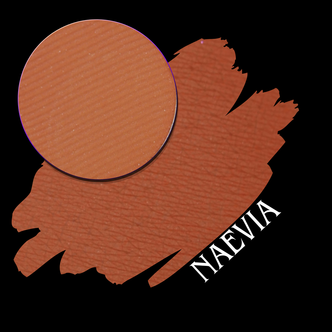 an eyeshadow pan of pressed pigment in a pumpkin orange color with a swatch and the name Naevia on the lower corner in white