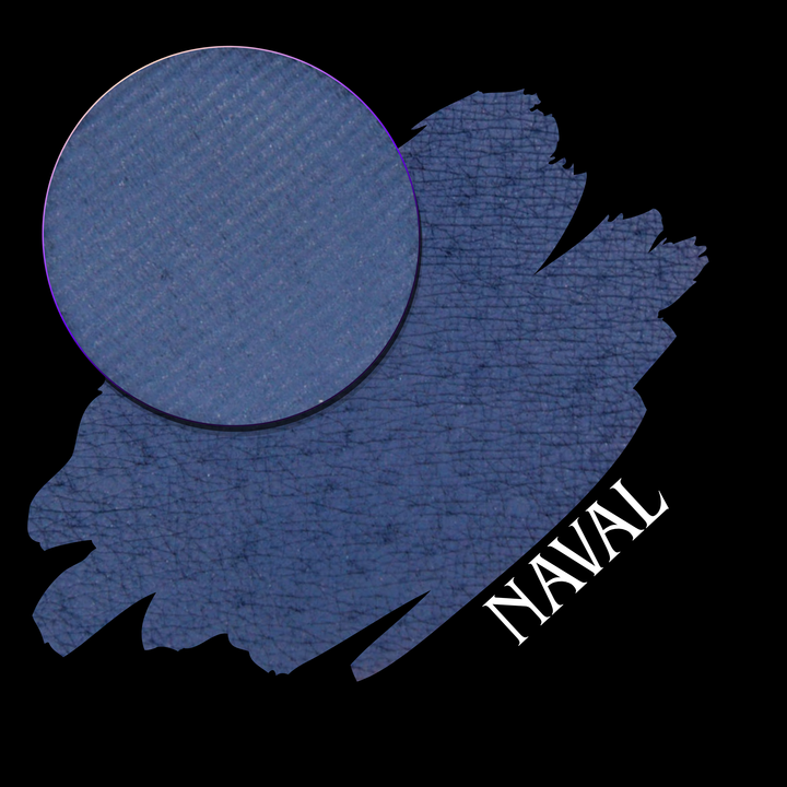 A textured navy blue eyeshadow makeup swatch with a circular eyeshadow pan, labeled 'NAVAL' in white text on a black background.