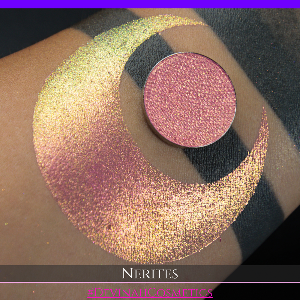 A round eyeshadow pan labeled 'NERITES' made by Devinah Cosmetics, placed over a large crescent moon swatch of the same shimmering multichrome eyeshadow on skin. The eyeshadow has a shimmer sparkle finish shifting between colors pink, yellow, gold, green.