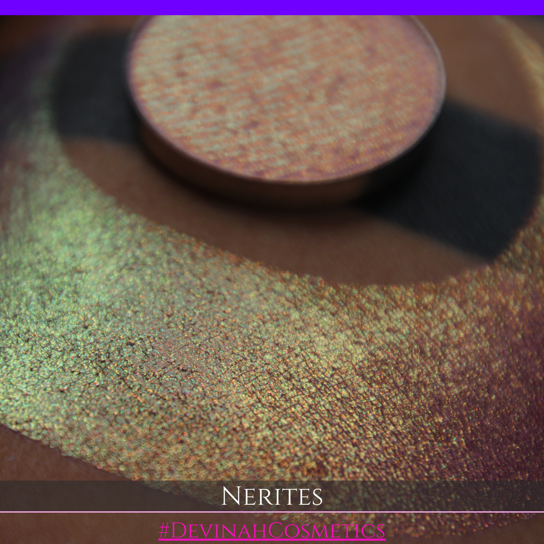 A round eyeshadow pan labeled 'NERITES' made by Devinah Cosmetics, placed over a large crescent moon swatch of the same shimmering multichrome eyeshadow on skin. The eyeshadow has a shimmer sparkle finish shifting between colors pink, yellow, gold, green.