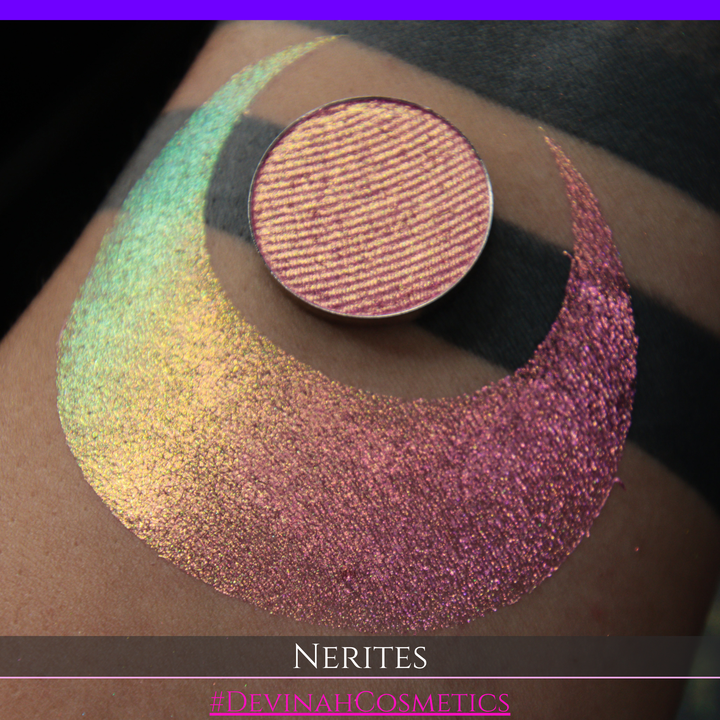 A round eyeshadow pan labeled 'NERITES' made by Devinah Cosmetics, placed over a large crescent moon swatch of the same shimmering multichrome eyeshadow on skin. The eyeshadow has a shimmer sparkle finish shifting between colors pink, yellow, gold, green.
