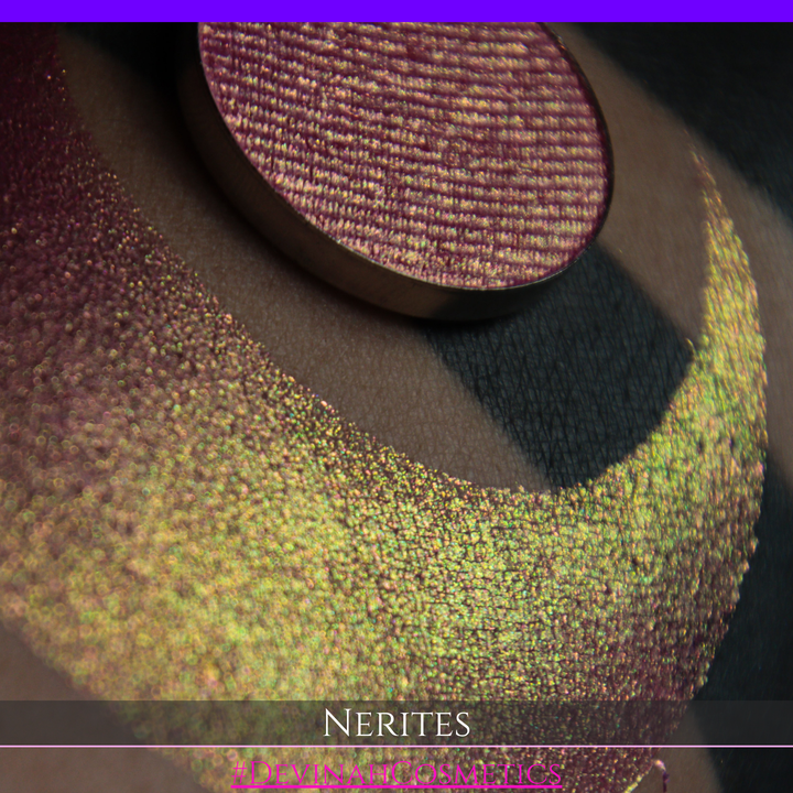 A round eyeshadow pan labeled 'NERITES' made by Devinah Cosmetics, placed over a large crescent moon swatch of the same shimmering multichrome eyeshadow on skin. The eyeshadow has a shimmer sparkle finish shifting between colors pink, yellow, gold, green.
