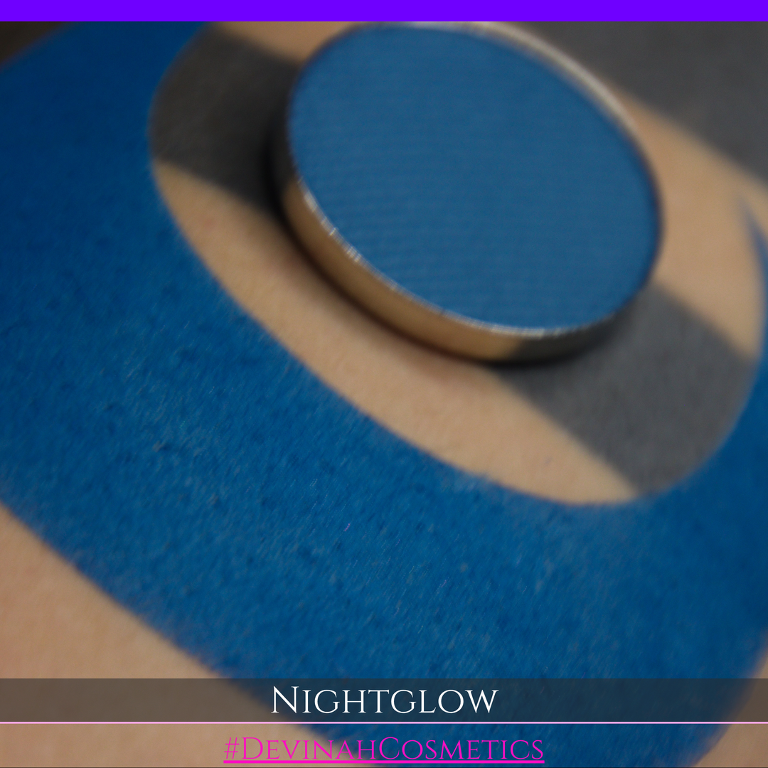 nightglow blue makeup eyeshadow pan with a crescent moon swatch to show the color
