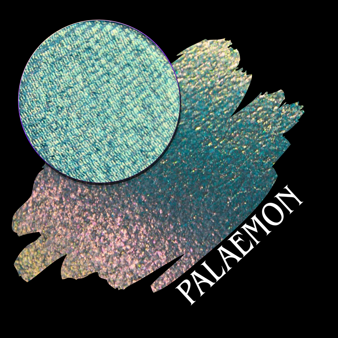 A round eyeshadow pan labeled 'PALAEMON' made by Devinah Cosmetics, placed over a large crescent moon swatch of the same shimmering shifty eyeshadow on skin. The eyeshadow has a duochrome multichrome shift between colors lime green, teal, yellow, gold, orange, pink, red.