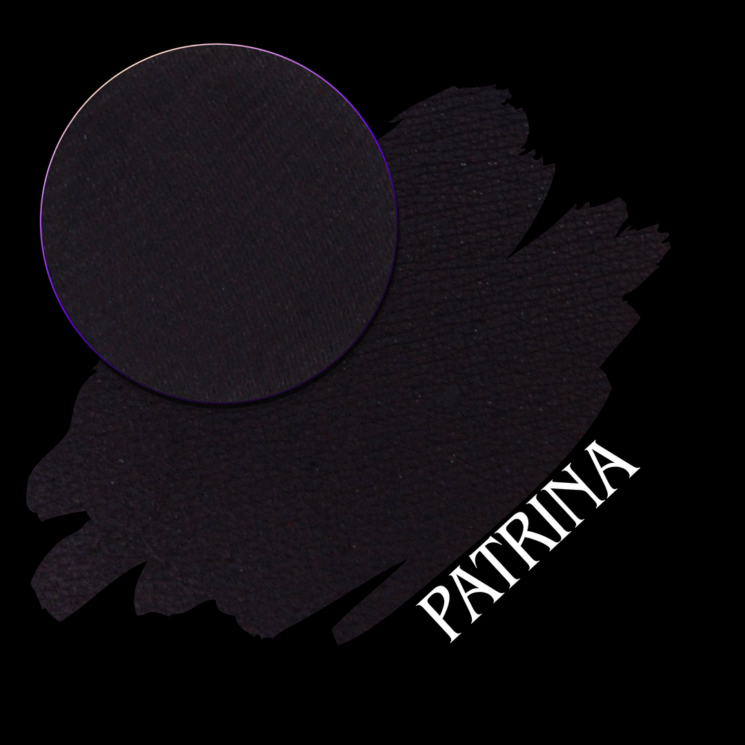 A blackened purple swatch with a matching matte eyeshadow pressed powder pan and the word 'PATRINA' in white, shown on a black background.