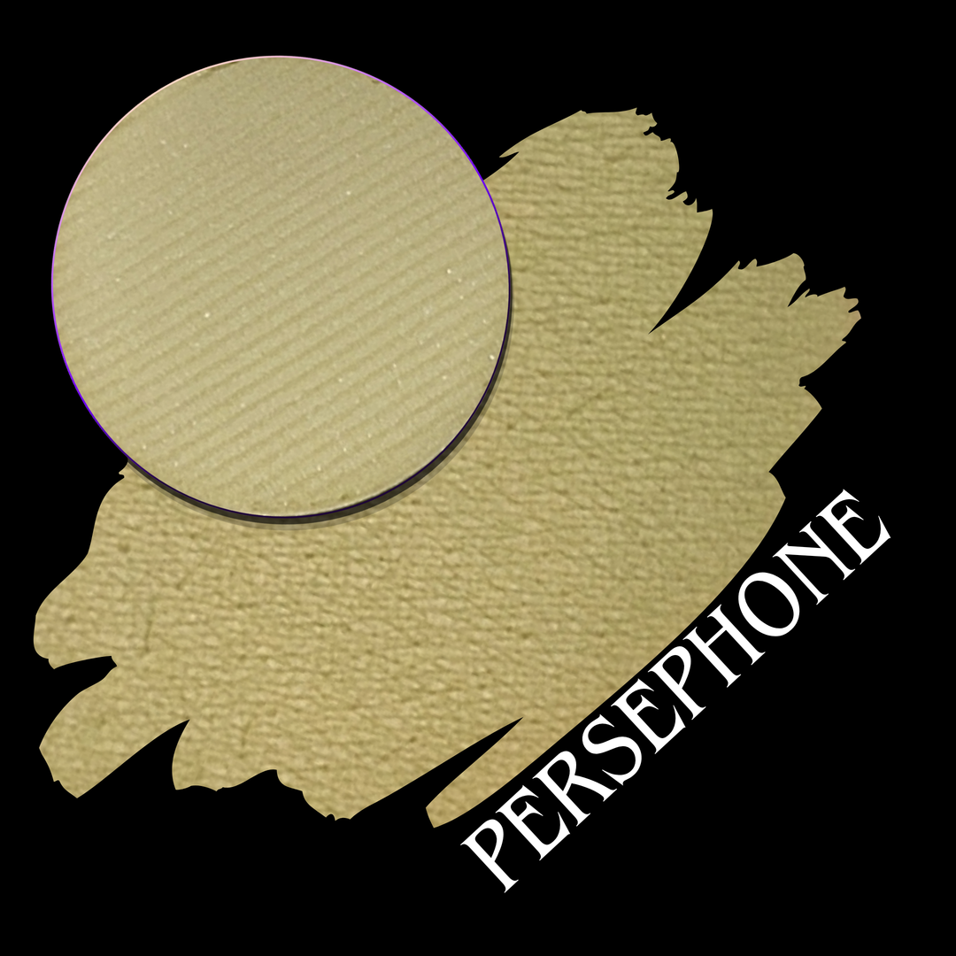 A textured makeup swatch in a desaturated chartreuse-beige shade, with a circular close-up of the eyeshadow pressed powder makeup pan. The word 'PERSEPHONE' is printed diagonally in white over the lower swatch on a black background.