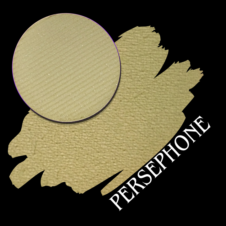 A textured makeup swatch in a desaturated chartreuse-beige shade, with a circular close-up of the eyeshadow pressed powder makeup pan. The word 'PERSEPHONE' is printed diagonally in white over the lower swatch on a black background.