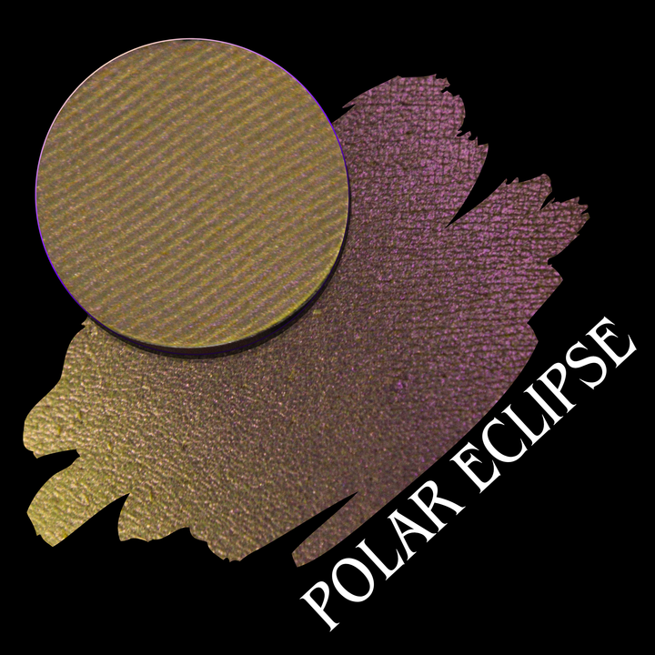 An eyeshadow pan shown above a swatch on a black background, with the text 'POLAR ECLIPSE' in white. The product color shifts from yellow to pink with a shimmering finish, hand made by Devinah Cosmetics.