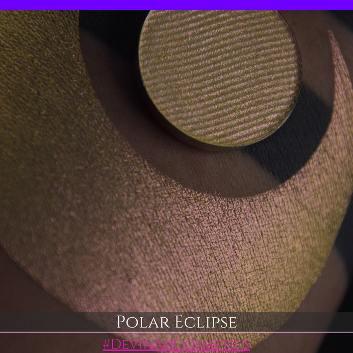 A close-up of a swatch and a circular  shimmering eyeshadow pan in a yellow-to-iridescent pink tone. Text at the bottom reads 'POLAR ECLIPSE' and '#DEVINAH Cosmetics'.