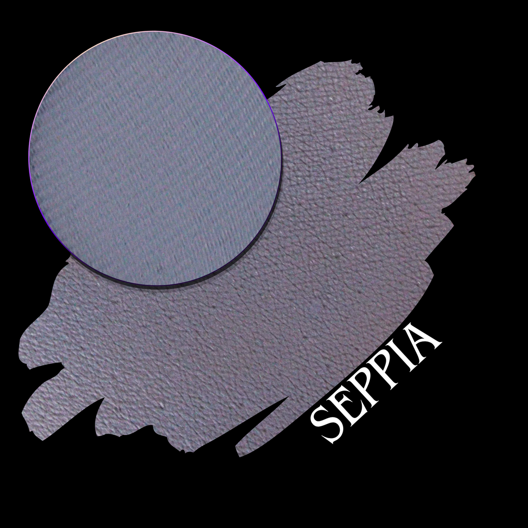 A swatch in a muted purple-gray color, featuring a circular close-up eyeshadow makeup pan and the word 'SEPPIA' in white text on a black background.