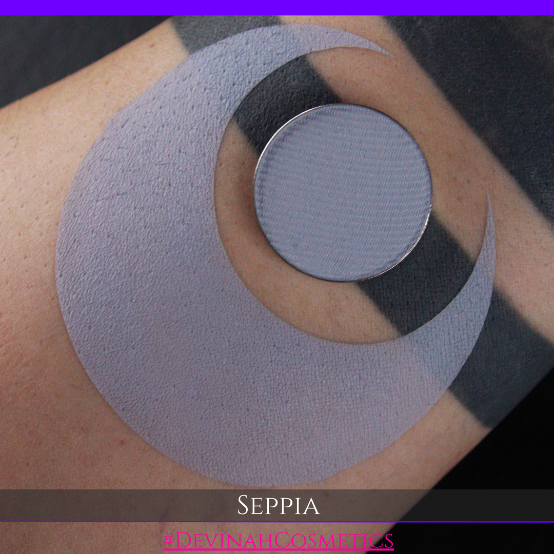 Eyeshadow matte pigment in a light gray color swatch on skin with 'Seppia' branding