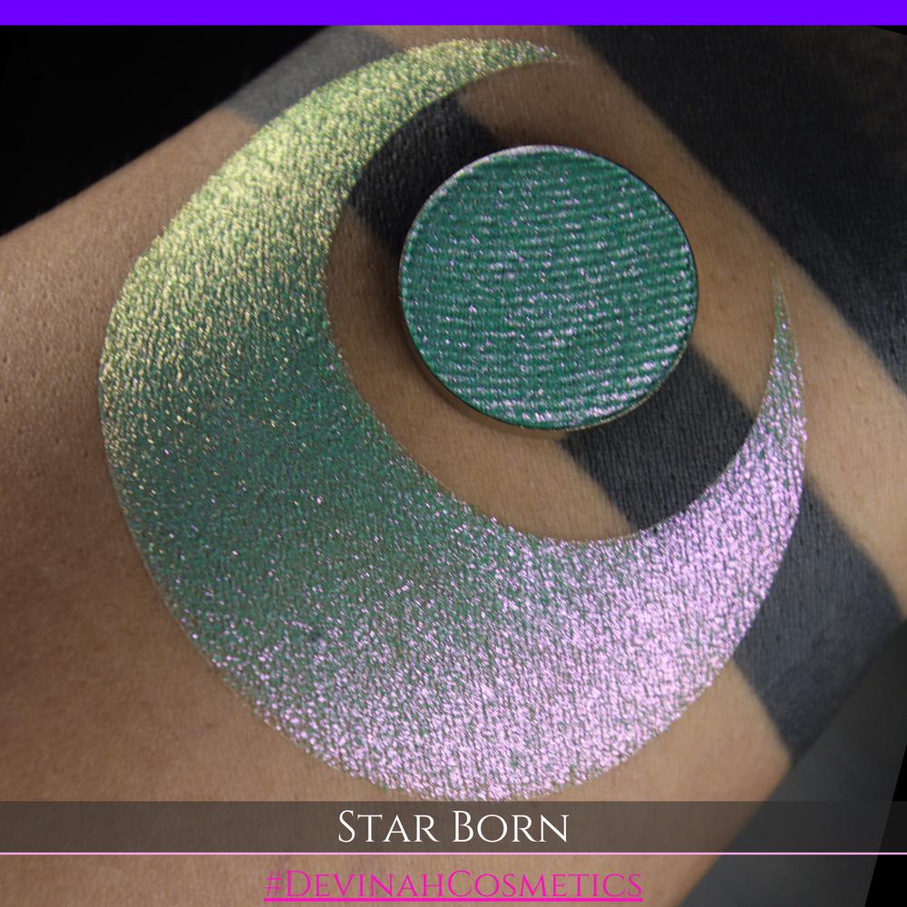 A close-up of a person's skin with a large iridescent crescent moon makeup swatch and a matching circular eyeshadow pan in the center. The text 'STAR BORN' and 'Devinah Cosmetics' appears at the bottom.