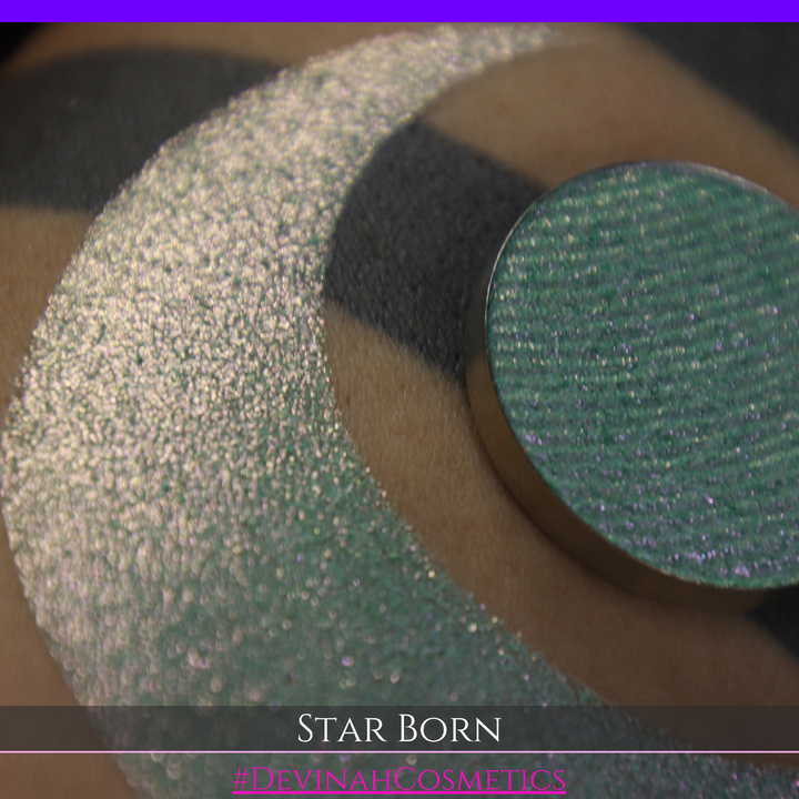 A close-up of a person's skin with a large iridescent crescent moon makeup swatch and a matching circular eyeshadow pan in the center. The text 'STAR BORN' and 'Devinah Cosmetics' appears at the bottom.