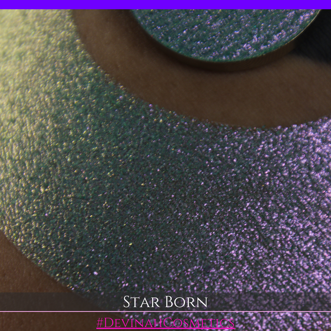 A close-up of a person's skin with a large iridescent crescent moon makeup swatch and a matching circular eyeshadow pan in the center. The text 'STAR BORN' and 'Devinah Cosmetics' appears at the bottom.