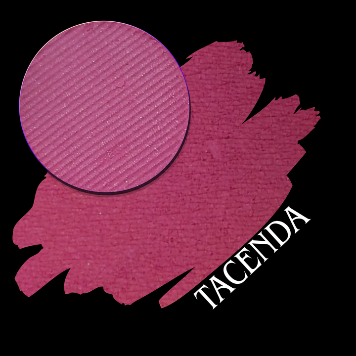 A circular makeup eyeshadow pan and a swatch in a deep magenta-pink shade labeled 'TACENDA' on a black background.