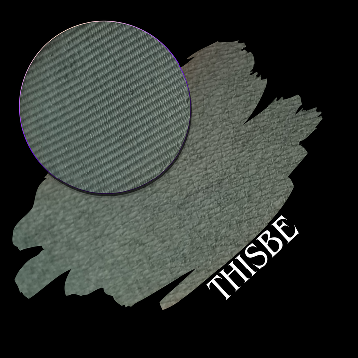 A swatch in a muted sage green color with a circular eyeshadow makeup pan, shown on a solid black background with the text 'THISBE' in white at the bottom