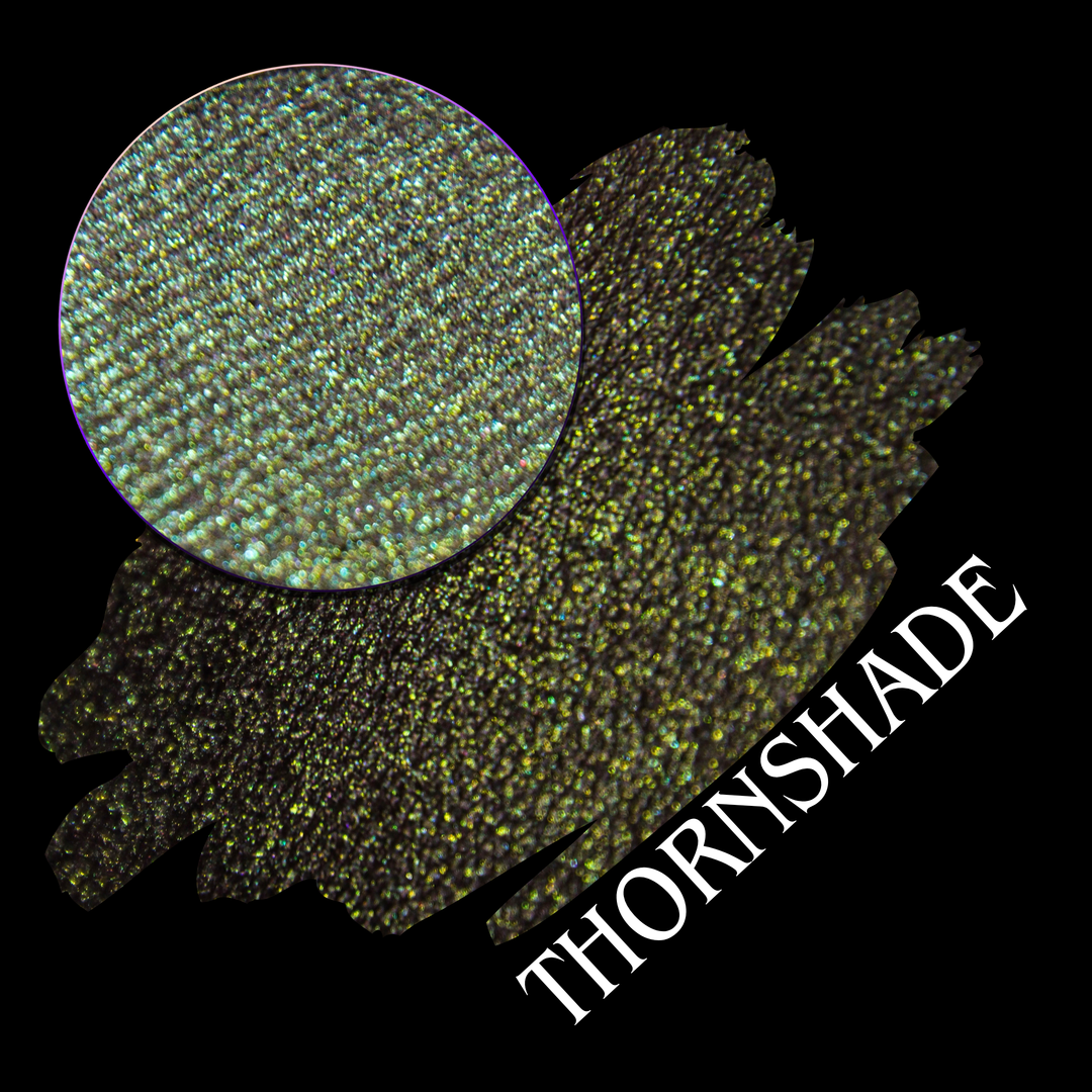 A black background with a textured glittery brown, green and gold eyeshadow swatch, a circular eyeshadow pan, and the word 'THORNSHADE' in white diagonal text made by Devinah Cosmetics.