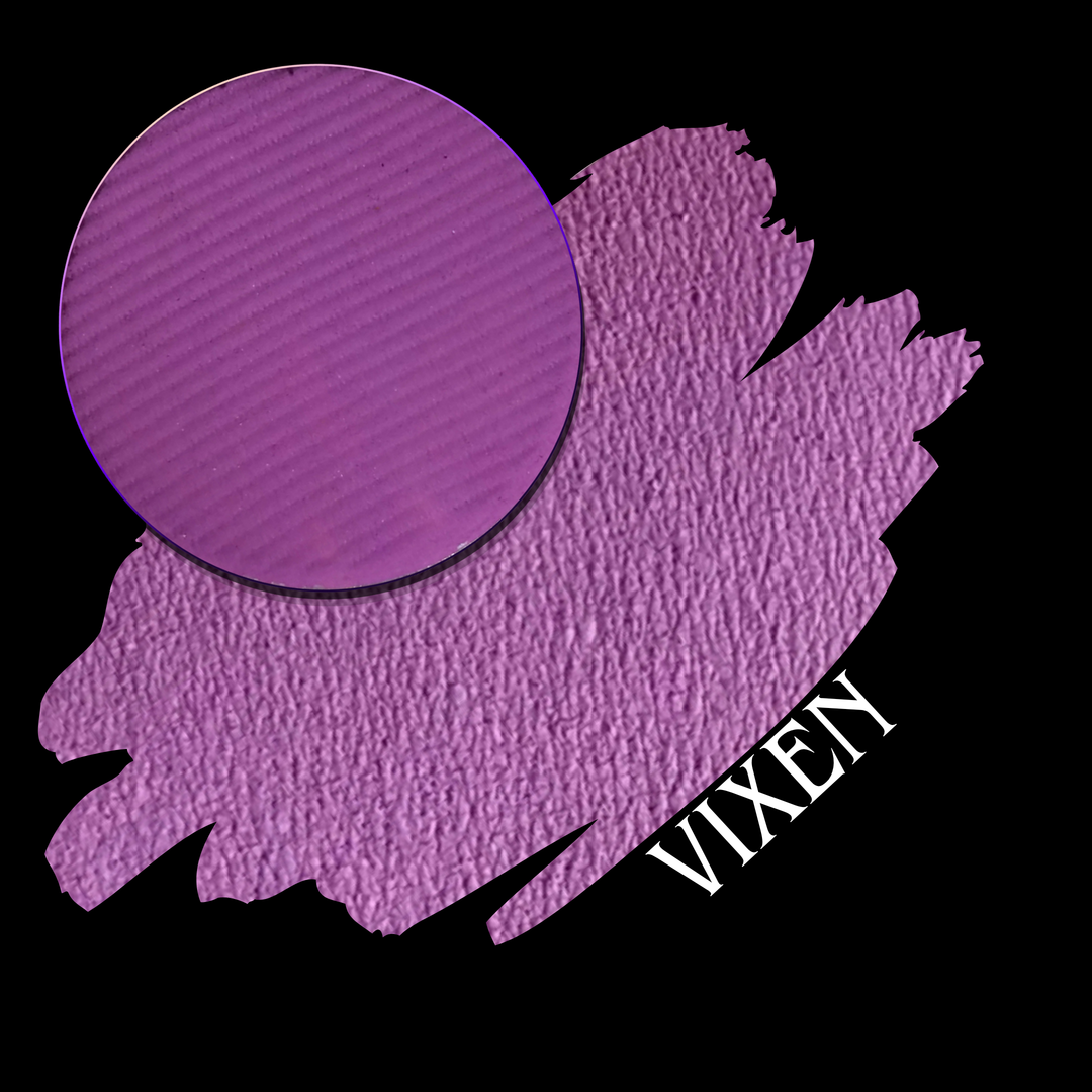 A purple swatch with a eyeshadow pan on a black background, labeled with the word VIXEN in white text.