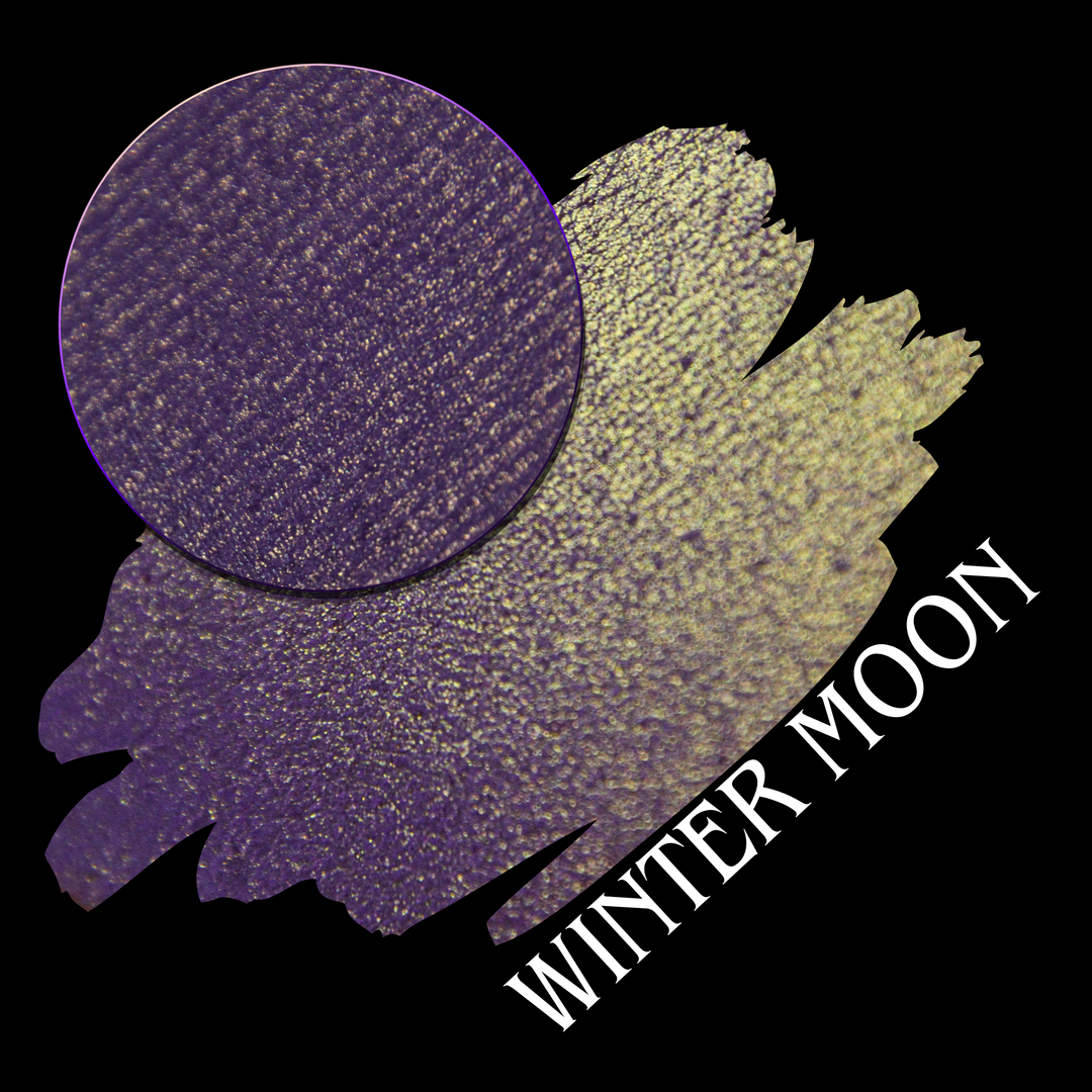 A textured eyeshadow swatch showing a deep purple color with fine gold shimmer, presented with an eyeshadow makeup pan on a black background, with the text 'WINTER MOON' in white hand made by Devinah Cosmetics.