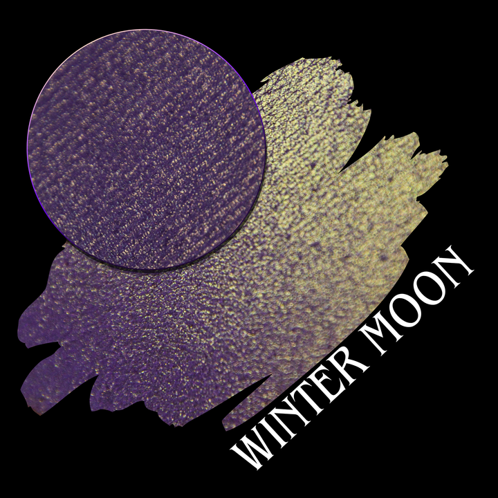 A textured eyeshadow swatch showing a deep purple color with fine gold shimmer, presented with an eyeshadow makeup pan on a black background, with the text 'WINTER MOON' in white hand made by Devinah Cosmetics.