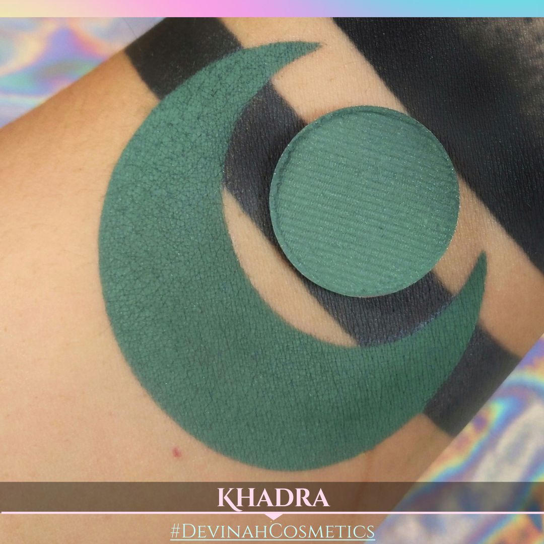Green makeup patch on skin with 'KHADRA' and '#DEVINAH COSMETICS' branding.