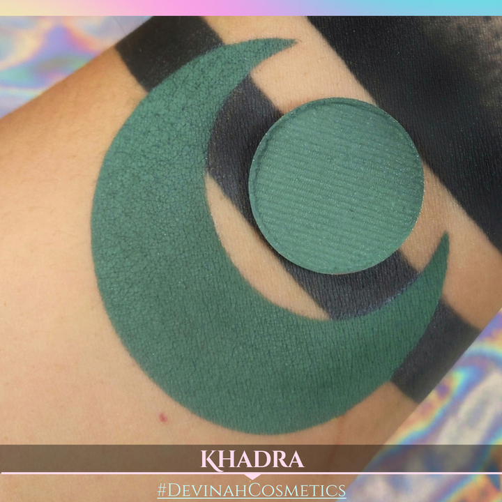 Green makeup patch on skin with 'KHADRA' and '#DEVINAH COSMETICS' branding.
