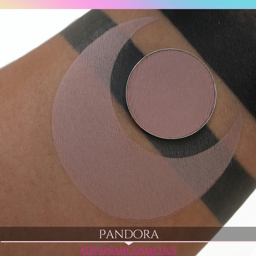 Makeup eyeshadow product on skin with 'Pandora' and '#DevinahCosmetics' branding.