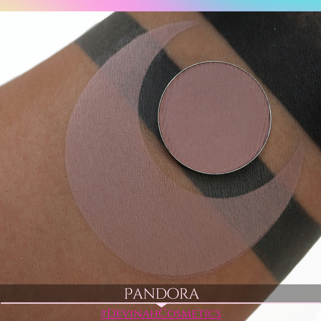 Makeup eyeshadow product on skin with 'Pandora' and '#DevinahCosmetics' branding.