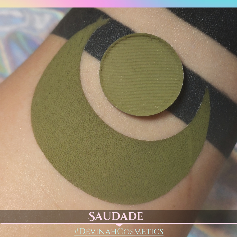 Green makeup product on skin with 'Saudade' and '#DevinaHCosmetics' text.